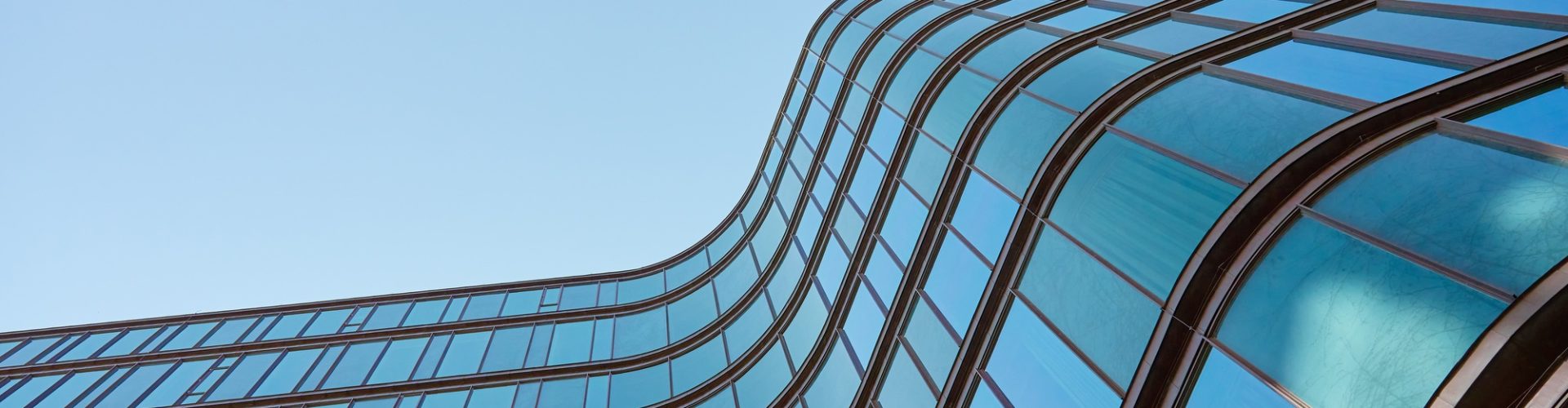 modern-curved-glass-building-exterior.jpg